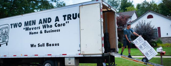 TWO MEN AND A TRUCK mover talking with customers 