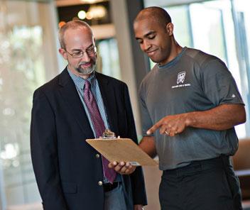 two men and a truck professional company mover talking with an office manager