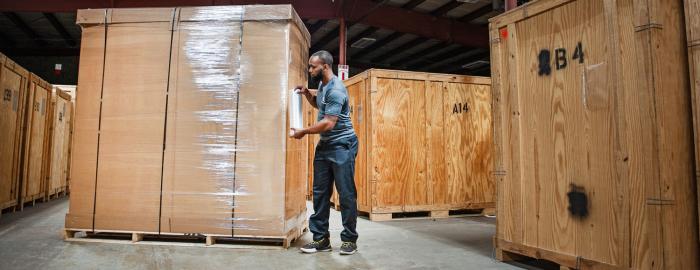 A mover wrapping a crate from the value flex service