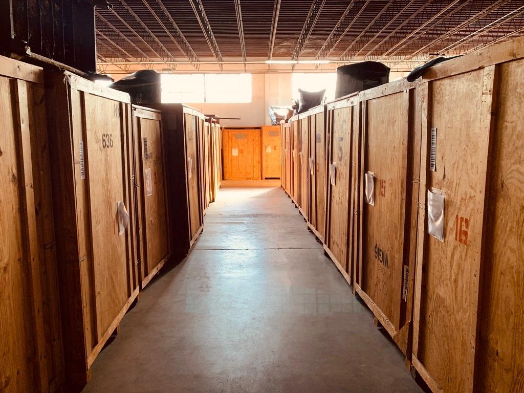 Aisle of storage crates in warehouse