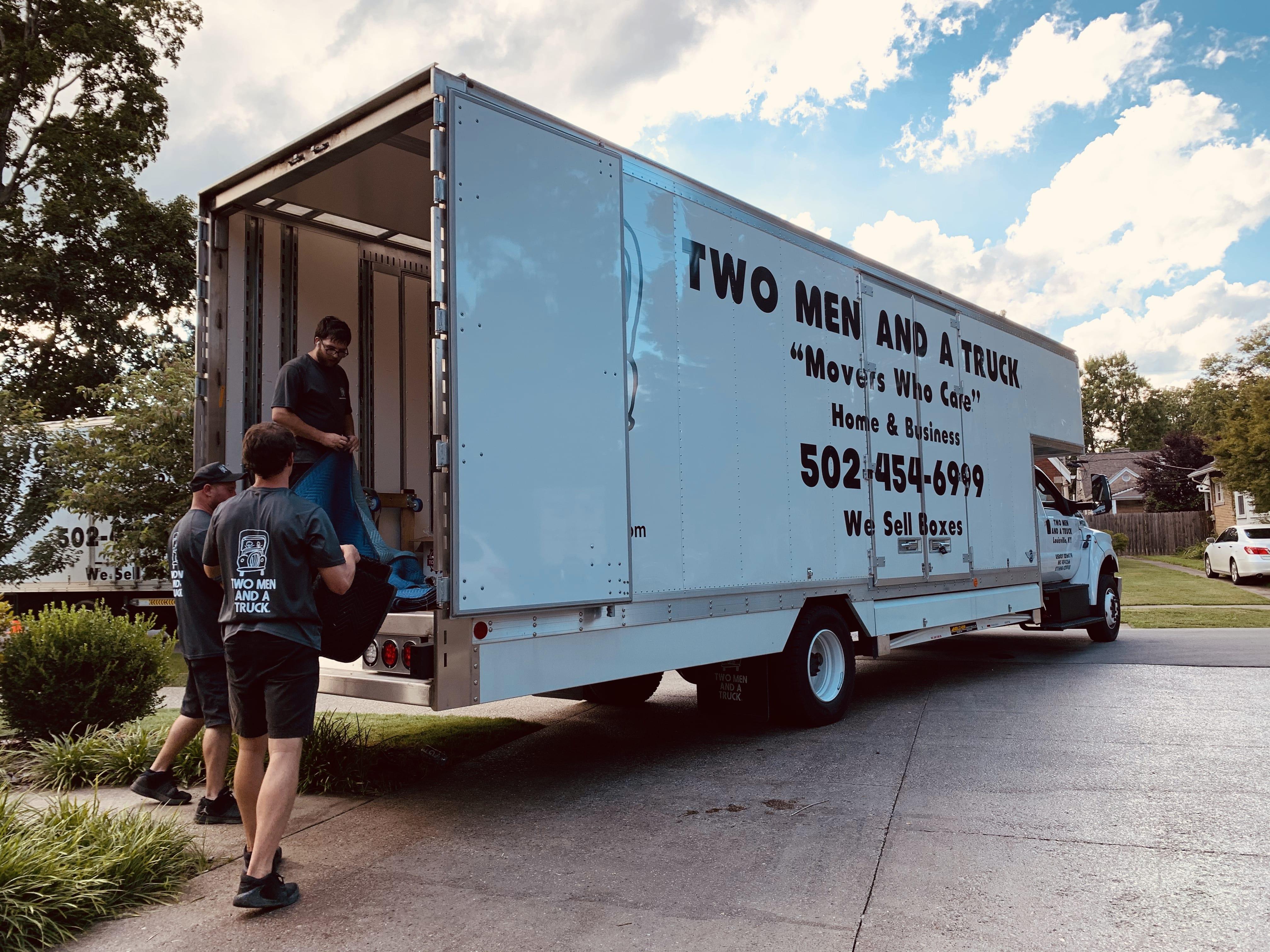 Movers folding pads on a truck