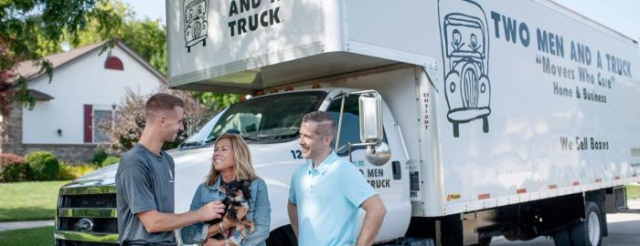 TWO MEN AND A TRUCK mover talking with customers 